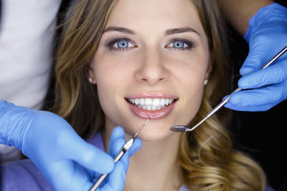 Woman in Dental Clinic with White Teeth
